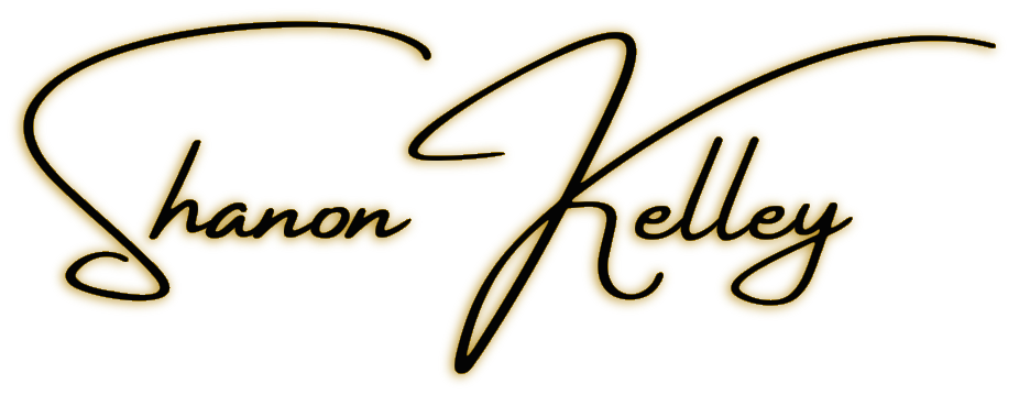 The logo of the Shanon Kelley Realty Group is displayed with a golden glow. The logo features the name "Shanon Kelley Realty Group" in bold, elegant font, with each word stacked on top of each other. The words are surrounded by a rectangular border, and the entire logo has a radiant golden glow emanating from it. The gold glow creates a sense of warmth and prestige, adding a touch of luxury to the logo.