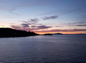Sunset over Departure Bay in Nanaimo, Vancouver Island, with silhouetted coastline and peaceful waters